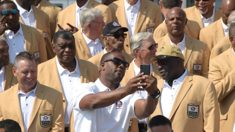 Aug 2, 2019; Canton, OH, USA; Ty Law takes a selfie with Pro Footballl Hall of Fame enshrinees at the Pro Football Hall of Fame. Mandatory Credit: Kirby Lee-USA TODAY Sports