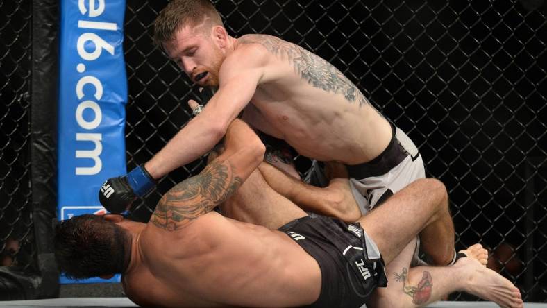 August 17, 2019; Anaheim, CA, USA; Cory Sandhegen lands a hit against Raphael Assuncao during UFC 241 at Honda Center. Mandatory Credit: Gary A. Vasquez-USA TODAY Sports