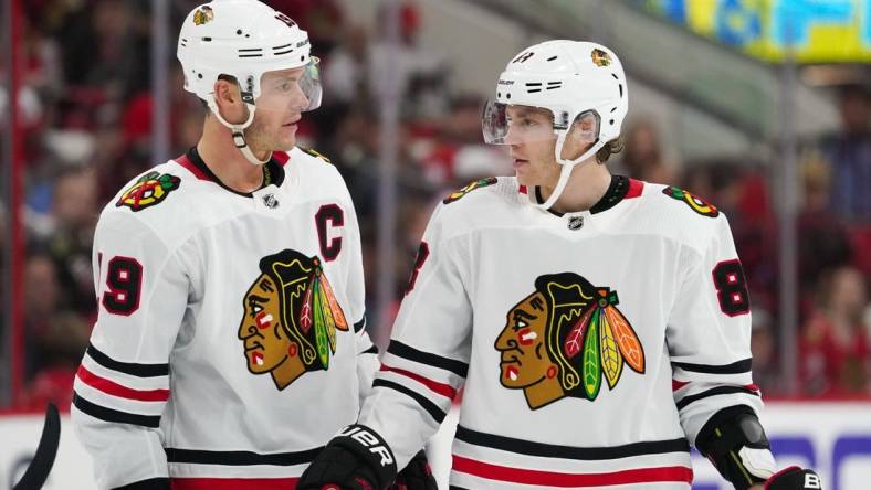 Oct 26, 2019; Raleigh, NC, USA;  Chicago Blackhawks center Jonathan Toews (19) and right wing Patrick Kane (88) talk against the Carolina Hurricanes at PNC Arena. The Carolina Hurricanes defeated the Chicago Blackhawks 4-0. Mandatory Credit: James Guillory-USA TODAY Sports