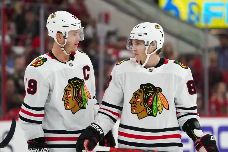 Oct 26, 2019; Raleigh, NC, USA;  Chicago Blackhawks center Jonathan Toews (19) and right wing Patrick Kane (88) talk against the Carolina Hurricanes at PNC Arena. The Carolina Hurricanes defeated the Chicago Blackhawks 4-0. Mandatory Credit: James Guillory-USA TODAY Sports