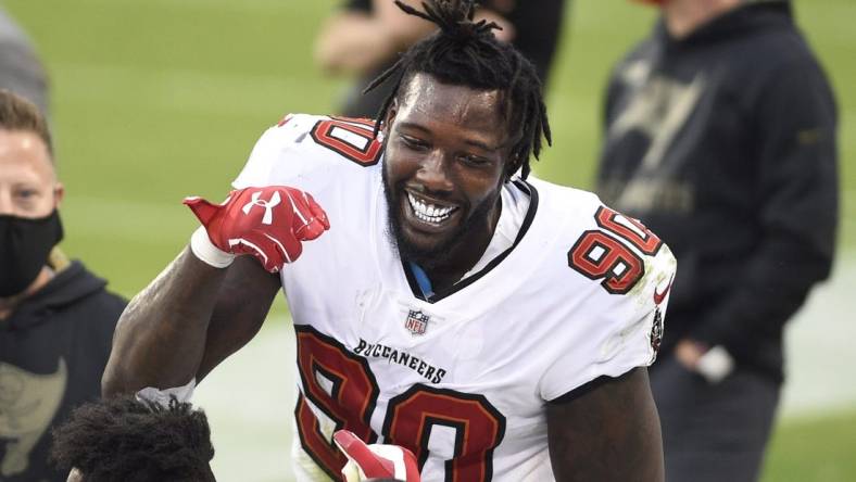 Nov 15, 2020; Charlotte, North Carolina, USA; Tampa Bay Buccaneers outside linebacker Jason Pierre-Paul (90) reacts on the sidelines after intercepting the ball in the third quarter at Bank of America Stadium. Mandatory Credit: Bob Donnan-USA TODAY Sports