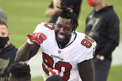 Nov 15, 2020; Charlotte, North Carolina, USA; Tampa Bay Buccaneers outside linebacker Jason Pierre-Paul (90) reacts on the sidelines after intercepting the ball in the third quarter at Bank of America Stadium. Mandatory Credit: Bob Donnan-USA TODAY Sports