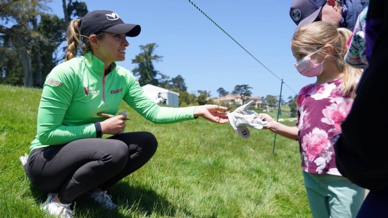 Jun 6, 2021; San Francisco, California, USA; Gaby Lopez gives a signed glove to a young golf spectator during the final round of the U.S. Women's Open golf tournament at The Olympic Club. Mandatory Credit: Kyle Terada-USA TODAY Sports