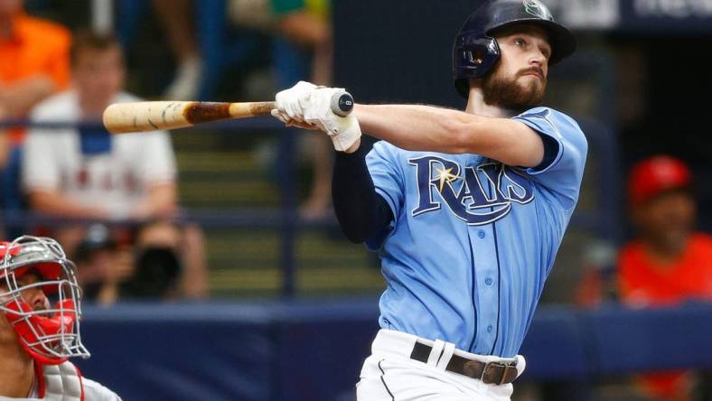 Jun 27, 2021; St. Petersburg, Florida, USA;  Tampa Bay Rays second baseman Brandon Lowe (8) hits a home run in the fifth inning during a game against the Los Angeles Angels at Tropicana Field. Mandatory Credit: Nathan Ray Seebeck-USA TODAY Sports