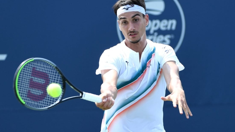Aug 9, 2021; Toronto, Ontario, Canada; Lorenzo Sonego of Italy plays a shot against Ugo Humbert of France in first round play at Aviva Centre. Mandatory Credit: Dan Hamilton-USA TODAY Sports