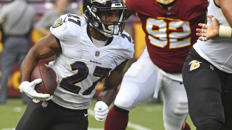 Aug 28, 2021; Landover, Maryland, USA; Baltimore Ravens running back J.K. Dobbins (27) carries the ball against the Washington Football Team during the first quarter at FedExField. Mandatory Credit: Brad Mills-USA TODAY Sports