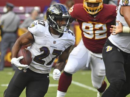 Aug 28, 2021; Landover, Maryland, USA; Baltimore Ravens running back J.K. Dobbins (27) carries the ball against the Washington Football Team during the first quarter at FedExField. Mandatory Credit: Brad Mills-USA TODAY Sports