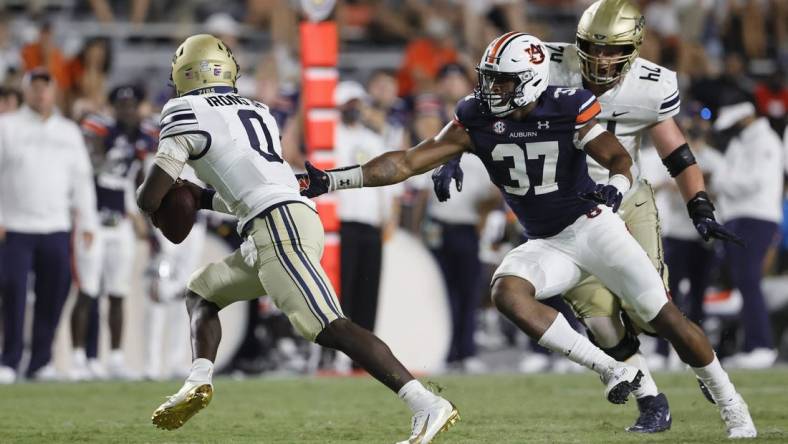 Sep 4, 2021; Auburn, Alabama, USA;  Akron Zips quarterback DJ Irons (0) avoids Auburn Tigers edge Romello Height (37) during the fourth quarter at Jordan-Hare Stadium. Mandatory Credit: John Reed-USA TODAY Sports