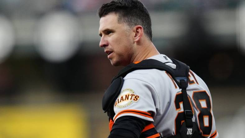 Sep 24, 2021; Denver, Colorado, USA; San Francisco Giants catcher Buster Posey (28) looks to towards the dugout in the first inning against the Colorado Rockies at Coors Field. Mandatory Credit: Ron Chenoy-USA TODAY Sports