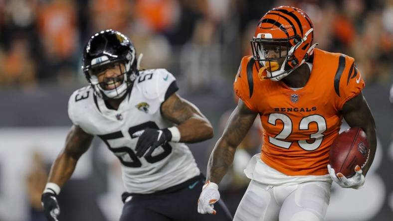 Sep 30, 2021; Cincinnati, Ohio, USA; Cincinnati Bengals cornerback Darius Phillips (23) runs with the ball past Jacksonville Jaguars linebacker Dakota Allen (53) in the first half at Paul Brown Stadium. Mandatory Credit: Katie Stratman-USA TODAY Sports