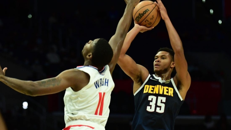Oct 4, 2021; Los Angeles, California, USA; Denver Nuggets guard PJ Dozier (35) shoots against Los Angeles Clippers forward Moses Wright (11) during the second half at Staples Center. Mandatory Credit: Gary A. Vasquez-USA TODAY Sports