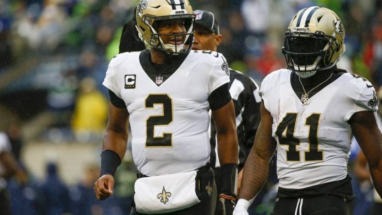 Oct 25, 2021; Seattle, Washington, USA; New Orleans Saints quarterback Jameis Winston (2) and running back Alvin Kamara (41) return to the sideline during the first quarter against the Seattle Seahawks at Lumen Field. Mandatory Credit: Joe Nicholson-USA TODAY Sports