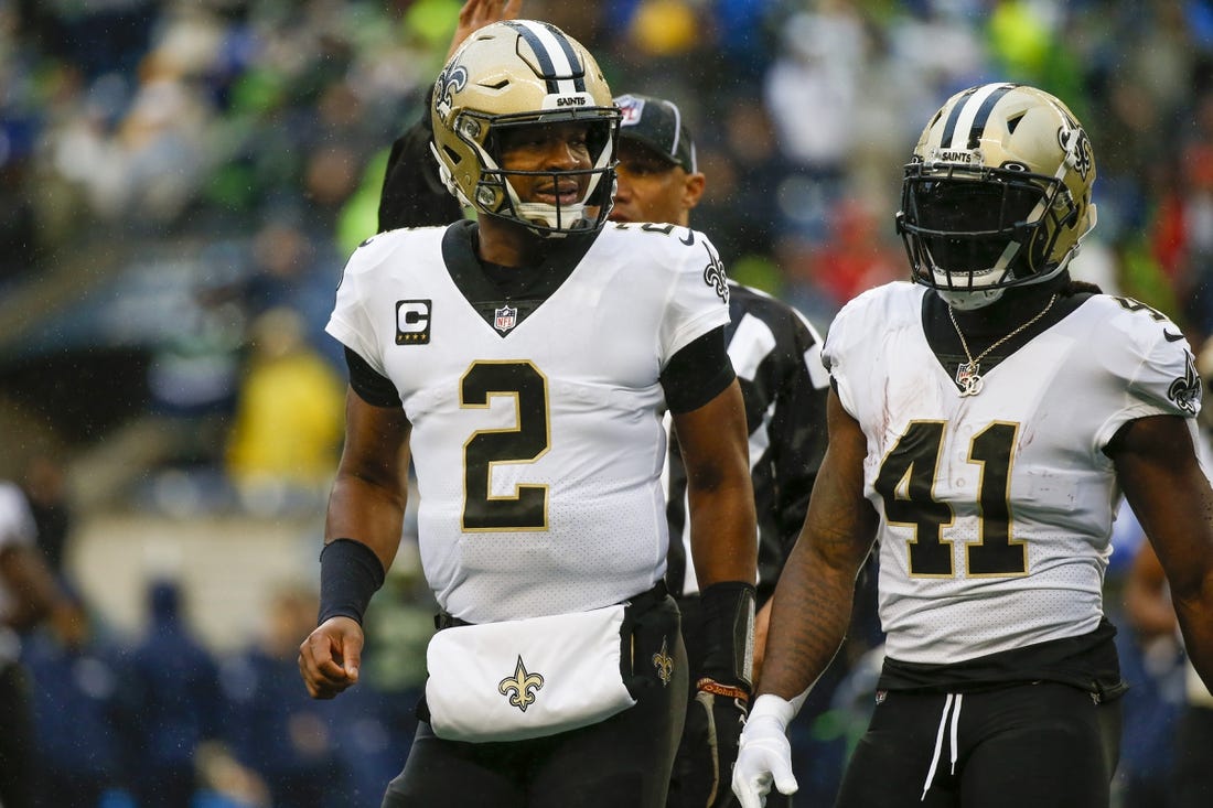 Oct 25, 2021; Seattle, Washington, USA; New Orleans Saints quarterback Jameis Winston (2) and running back Alvin Kamara (41) return to the sideline during the first quarter against the Seattle Seahawks at Lumen Field. Mandatory Credit: Joe Nicholson-USA TODAY Sports