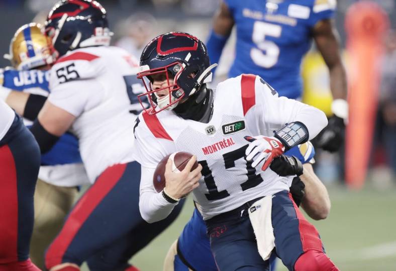 Nov 6, 2021; Winnipeg, Manitoba, CAN; Montreal Alouettes quarterback Trevor Harris (17) is tackled from behind during a Canadian football League game at IG Field. Mandatory Credit: Bruce Fedyck-USA TODAY Sports