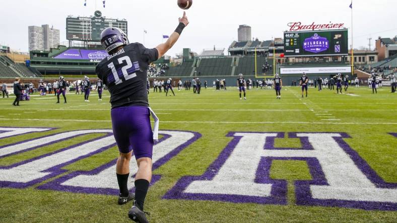 Nov 20, 2021; Chicago, Illinois, USA; Northwestern Wildcats quarterback Ryan Hilinski (12) warms up before the game between the Northwestern Wildcats and the Purdue Boilermakers at Wrigley Field. Mandatory Credit: Jon Durr-USA TODAY Sports