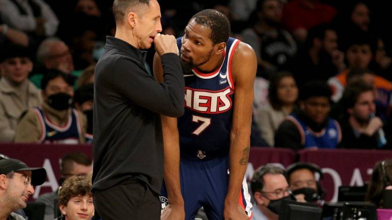 Nov 27, 2021; Brooklyn, New York, USA; Brooklyn Nets head coach Steve Nash talks to forward Kevin Durant (7) during the fourth quarter against the Phoenix Suns at Barclays Center. Mandatory Credit: Brad Penner-USA TODAY Sports