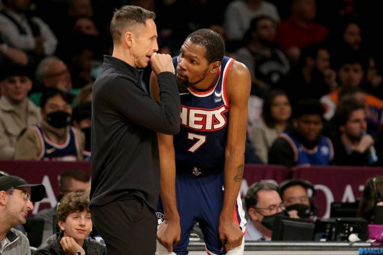 Nov 27, 2021; Brooklyn, New York, USA; Brooklyn Nets head coach Steve Nash talks to forward Kevin Durant (7) during the fourth quarter against the Phoenix Suns at Barclays Center. Mandatory Credit: Brad Penner-USA TODAY Sports