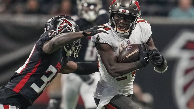 Dec 5, 2021; Atlanta, Georgia, USA; Tampa Bay Buccaneers wide receiver Chris Godwin (14) runs against Atlanta Falcons cornerback Darren Hall (34) during the first half at Mercedes-Benz Stadium. Mandatory Credit: Dale Zanine-USA TODAY Sports