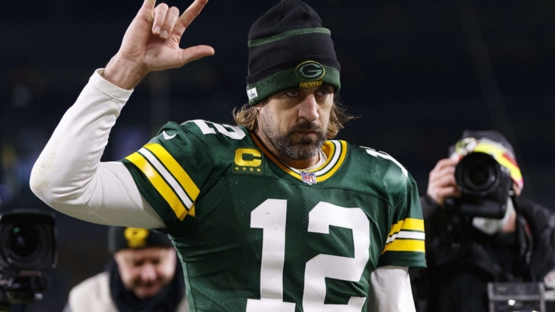 Dec 12, 2021; Green Bay, Wisconsin, USA; Green Bay Packers quarterback Aaron Rodgers (12) celebrates as he walks off the field following the game against the Chicago Bears at Lambeau Field. Mandatory Credit: Jeff Hanisch-USA TODAY Sports