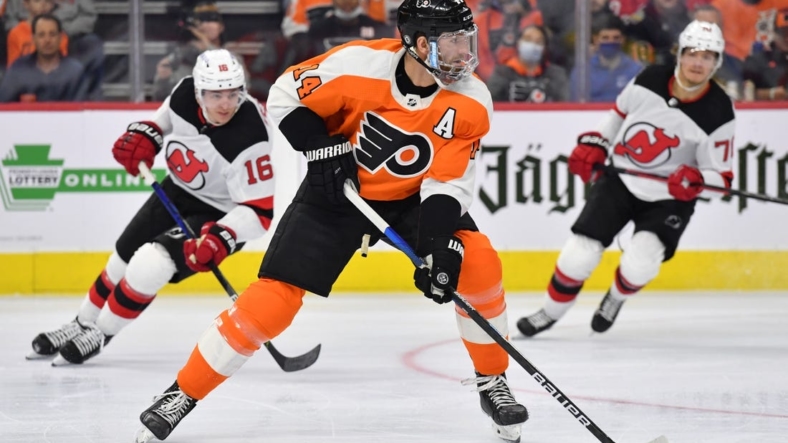Dec 14, 2021; Philadelphia, Pennsylvania, USA; Philadelphia Flyers center Sean Couturier (14) carries the puck against the New Jersey Devils during the second  period at Wells Fargo Center. Mandatory Credit: Eric Hartline-USA TODAY Sports