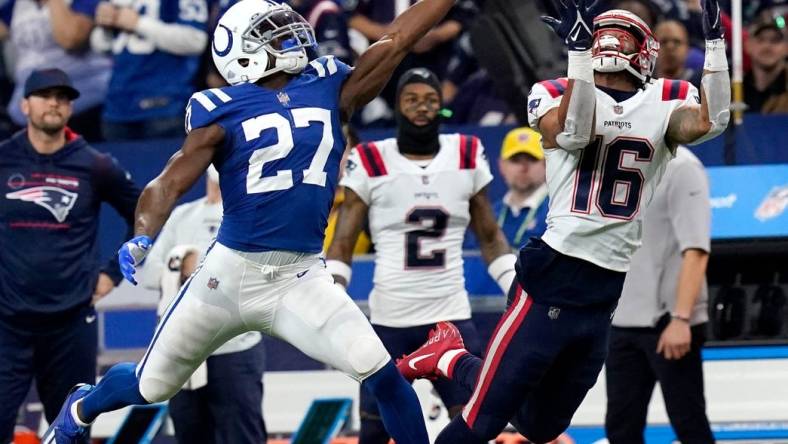 A pass intended for New England Patriots wide receiver Jakobi Meyers (16) goes incomplete as Indianapolis Colts cornerback Xavier Rhodes (27) reaches for the ball Saturday, Dec. 18, 2021, during a game against the New England Patriots at Lucas Oil Stadium in Indianapolis.