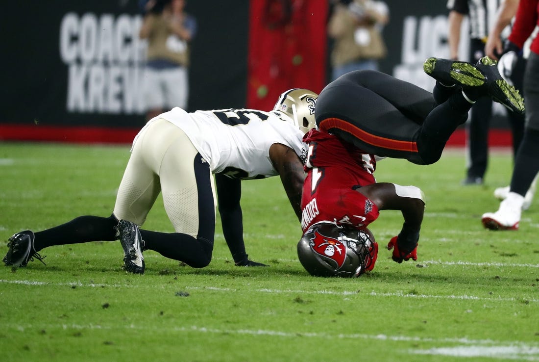 Dec 19, 2021; Tampa, Florida, USA; Tampa Bay Buccaneers wide receiver Chris Godwin (14) falls on his head after he catches the ball against the New Orleans Saints during the first half at Raymond James Stadium. Mandatory Credit: Kim Klement-USA TODAY Sports