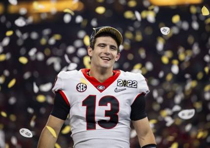 Jan 10, 2022; Indianapolis, IN, USA; Georgia Bulldogs quarterback Stetson Bennett (13) celebrates after defeating the Alabama Crimson Tide in the 2022 CFP college football national championship game at Lucas Oil Stadium. Mandatory Credit: Mark J. Rebilas-USA TODAY Sports