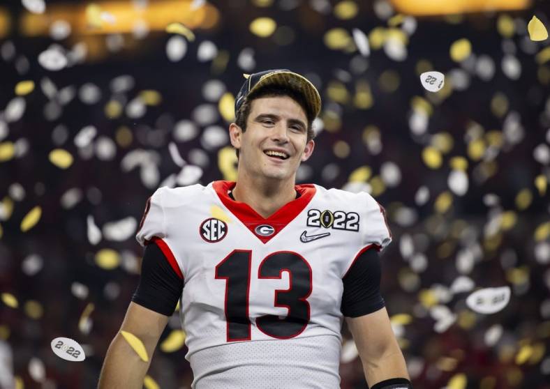 Jan 10, 2022; Indianapolis, IN, USA; Georgia Bulldogs quarterback Stetson Bennett (13) celebrates after defeating the Alabama Crimson Tide in the 2022 CFP college football national championship game at Lucas Oil Stadium. Mandatory Credit: Mark J. Rebilas-USA TODAY Sports