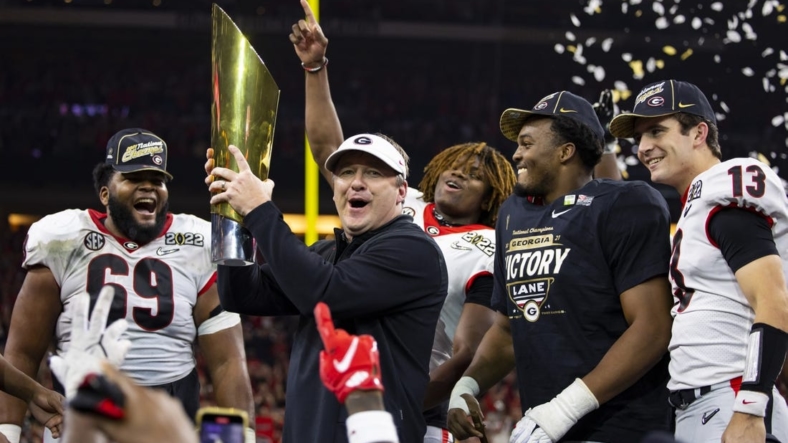 Jan 10, 2022; Indianapolis, IN, USA; Georgia Bulldogs head coach Kirby Smart celebrates with the championship trophy after defeating the Alabama Crimson Tide in the 2022 CFP college football national championship game at Lucas Oil Stadium. Mandatory Credit: Mark J. Rebilas-USA TODAY Sports