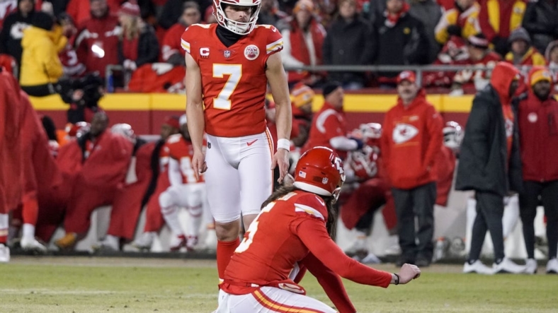 Jan 23, 2022; Kansas City, Missouri, USA; Kansas City Chiefs kicker Harrison Butker (7) prepares to kick a field goal with punter Tommy Townsend (5) holding against the Buffalo Bills during an AFC Divisional playoff football game at GEHA Field at Arrowhead Stadium. Mandatory Credit: Denny Medley-USA TODAY Sports