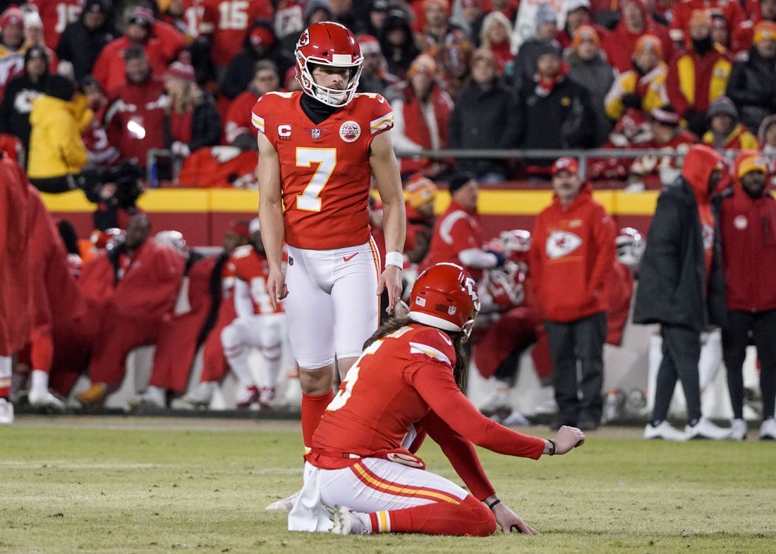 Jan 23, 2022; Kansas City, Missouri, USA; Kansas City Chiefs kicker Harrison Butker (7) prepares to kick a field goal with punter Tommy Townsend (5) holding against the Buffalo Bills during an AFC Divisional playoff football game at GEHA Field at Arrowhead Stadium. Mandatory Credit: Denny Medley-USA TODAY Sports