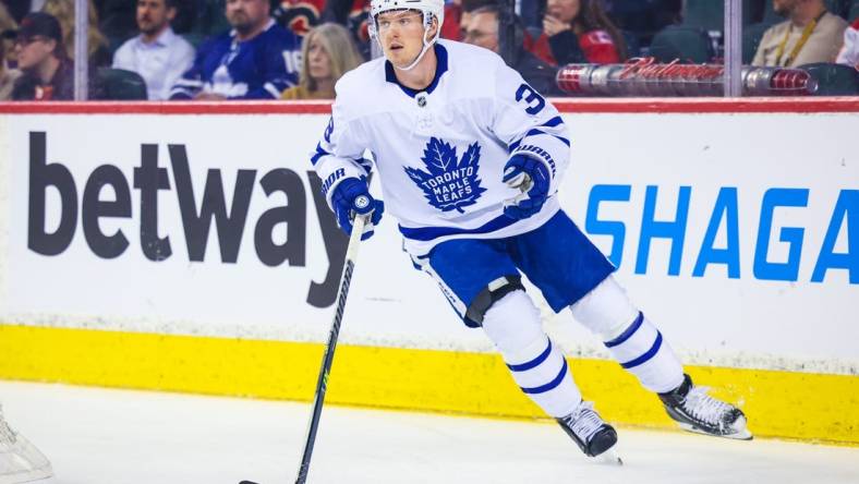 Feb 10, 2022; Calgary, Alberta, CAN; Toronto Maple Leafs defenseman Rasmus Sandin (38) skates with the puck against the Calgary Flames during the first period at Scotiabank Saddledome. Mandatory Credit: Sergei Belski-USA TODAY Sports