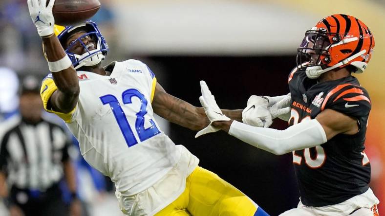 Los Angeles Rams wide receiver Van Jefferson (12) stretches for a pass before it lands incomplete under pressure from Cincinnati Bengals cornerback Eli Apple (20) in the fourth quarter of Super Bowl 56 between the Cincinnati Bengals and the Los Angeles Rams at SoFi Stadium in Inglewood, Calif., on Sunday, Feb. 13, 2022. The Rams came back in the final minutes of the game to win 23-20 on their home field.

Super Bowl 56 Cincinnati Bengals Vs La Rams