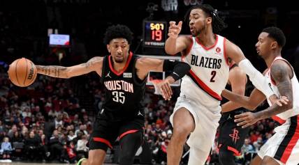 Mar 25, 2022; Portland, Oregon, USA; Houston Rockets center Christian Wood (35) drives to the basket on Portland Trail Blazers forward Trendon Watford (2) during the second half of the game at Moda Center. The Rockets won 125-106. Mandatory Credit: Steve Dykes-USA TODAY Sports