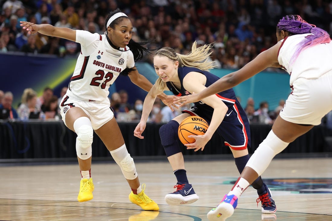 Apr 3, 2022; Minneapolis, MN, USA; UConn Huskies guard Paige Bueckers (5) controls the ball between South Carolina Gamecocks guard Bree Hall (23) and South Carolina Gamecocks forward Aliyah Boston (4) in the Final Four championship game of the women's college basketball NCAA Tournament at Target Center. Mandatory Credit: Matt Krohn-USA TODAY Sports