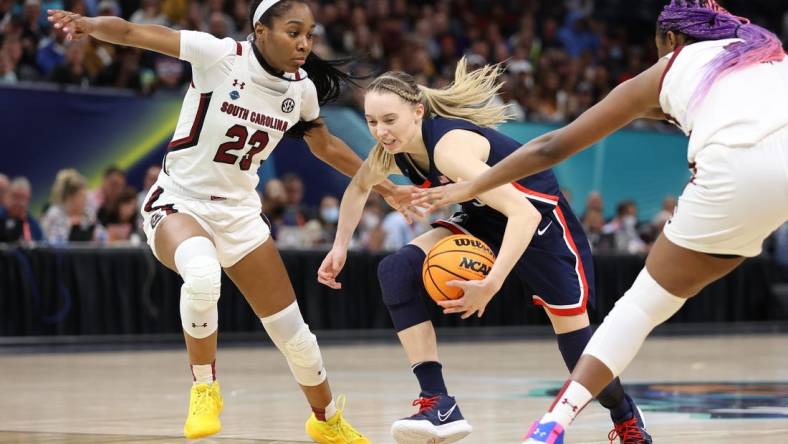 Apr 3, 2022; Minneapolis, MN, USA; UConn Huskies guard Paige Bueckers (5) controls the ball between South Carolina Gamecocks guard Bree Hall (23) and South Carolina Gamecocks forward Aliyah Boston (4) in the Final Four championship game of the women's college basketball NCAA Tournament at Target Center. Mandatory Credit: Matt Krohn-USA TODAY Sports