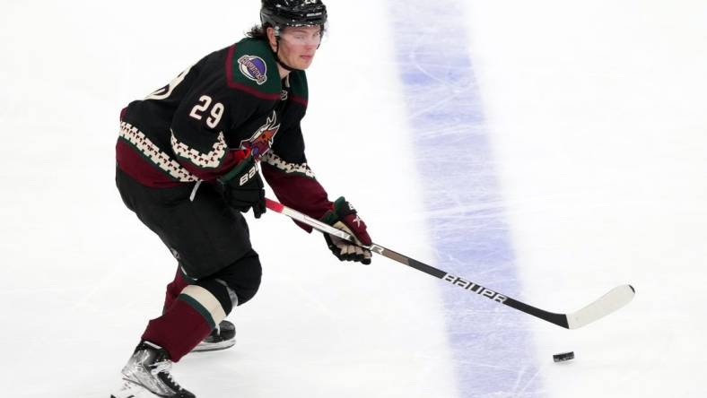 Apr 18, 2022; Glendale, Arizona, USA; Arizona Coyotes center Barrett Hayton (29) skates the puck against the Carolina Hurricanes during the third period at Gila River Arena. Mandatory Credit: Joe Camporeale-USA TODAY Sports