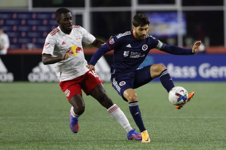 Apr 2, 2022; Foxborough, Massachusetts, USA; New England Revolution midfielder Carles Gil (10) controls the ball in front of New York Red Bulls midfielder Dru Yearwood (16) during the first half at Gillette Stadium. Mandatory Credit: Winslow Townson-USA TODAY Sports