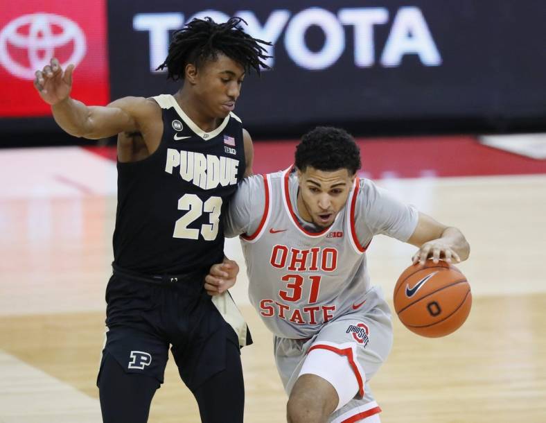 Ohio State Buckeyes forward Seth Towns (31) dribbles past Purdue Boilermakers guard Jaden Ivey (23) during the second half of the men's basketball game at Value City Arena in Columbus on Tuesday, Jan. 19, 2021. Purdue won 67-65.

Ohio State Vs Purdue Men S Basketball