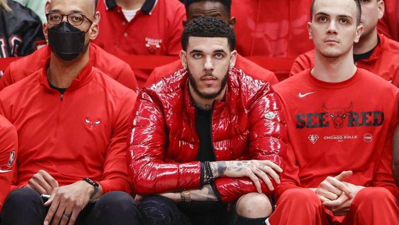 Apr 22, 2022; Chicago, Illinois, USA; Chicago Bulls guard Lonzo Ball (center) looks on from the bench during the second half of game three of the first round for the 2022 NBA playoffs against the Milwaukee Bucks at United Center. Mandatory Credit: Kamil Krzaczynski-USA TODAY Sports