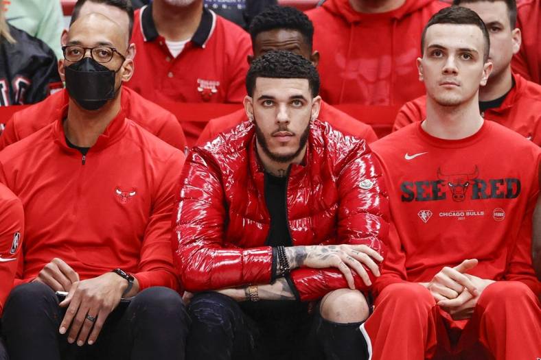 Apr 22, 2022; Chicago, Illinois, USA; Chicago Bulls guard Lonzo Ball (center) looks on from the bench during the second half of game three of the first round for the 2022 NBA playoffs against the Milwaukee Bucks at United Center. Mandatory Credit: Kamil Krzaczynski-USA TODAY Sports