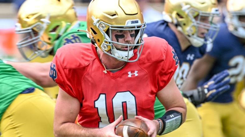 Apr 23, 2022; Notre Dame, Indiana, USA; Notre Dame Fighting Irish quarterback Drew Pyne (10) looks to hand off in the first quarter of the Blue-Gold Game at Notre Dame Stadium. Mandatory Credit: Matt Cashore-USA TODAY Sports