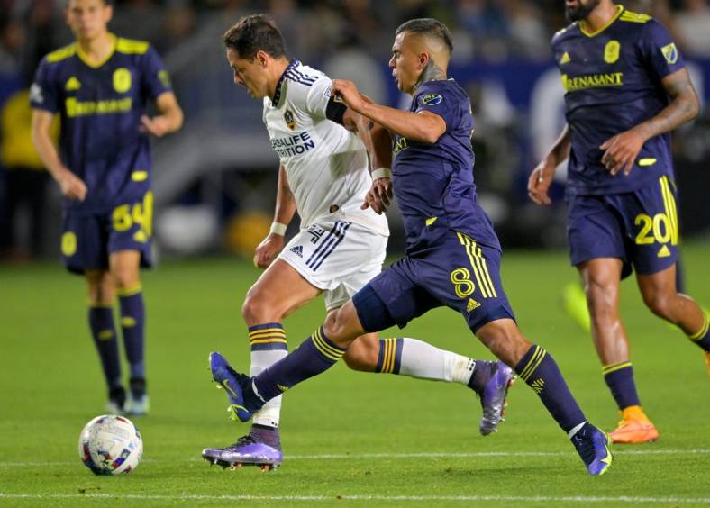 Apr 23, 2022; Carson, California, USA; Los Angeles Galaxy forward Javier Hernandez (14) and Nashville SC midfielder Randall Leal (8) battle for the ball in the second half at Dignity Health Sports Park. Mandatory Credit: Jayne Kamin-Oncea-USA TODAY Sports