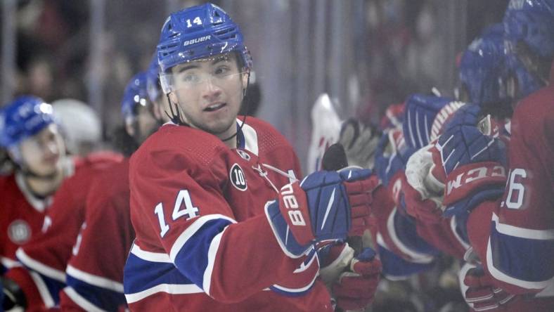 Apr 24, 2022; Montreal, Quebec, CAN; Montreal Canadiens forward Nick Suzuki (14) celebrates with teammates after scoring a goal against the Boston Bruins during the third period at the Bell Centre. Mandatory Credit: Eric Bolte-USA TODAY Sports