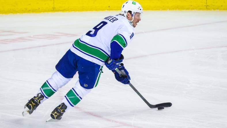 Apr 23, 2022; Calgary, Alberta, CAN; Vancouver Canucks center J.T. Miller (9) skates with the puck against the Calgary Flames during the first period at Scotiabank Saddledome. Mandatory Credit: Sergei Belski-USA TODAY Sports