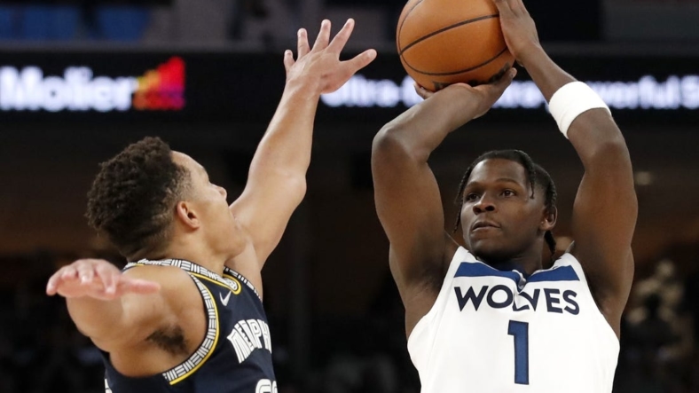 Apr 26, 2022; Memphis, Tennessee, USA; Memphis Grizzlies guard Desmond Bane (22) guards Minnesota Timberwolves forward Anthony Edwards (1) as he shoots the ball during the second half of game five of the first round for the 2022 NBA playoffs at FedExForum. Mandatory Credit: Christine Tannous-USA TODAY Sports