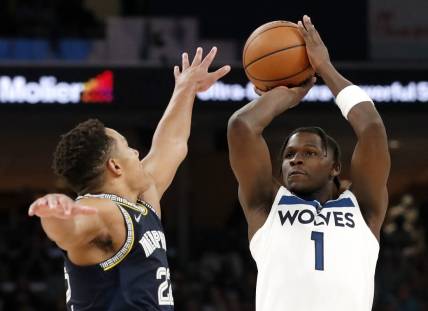 Apr 26, 2022; Memphis, Tennessee, USA; Memphis Grizzlies guard Desmond Bane (22) guards Minnesota Timberwolves forward Anthony Edwards (1) as he shoots the ball during the second half of game five of the first round for the 2022 NBA playoffs at FedExForum. Mandatory Credit: Christine Tannous-USA TODAY Sports