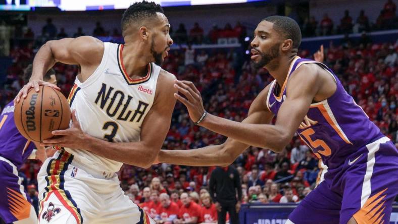 Apr 28, 2022; New Orleans, Louisiana, USA;  New Orleans Pelicans guard CJ McCollum (3) is defended by Phoenix Suns forward Mikal Bridges (25) during the first half of game six of the first round for the 2022 NBA playoffs at Smoothie King Center. Mandatory Credit: Stephen Lew-USA TODAY Sports