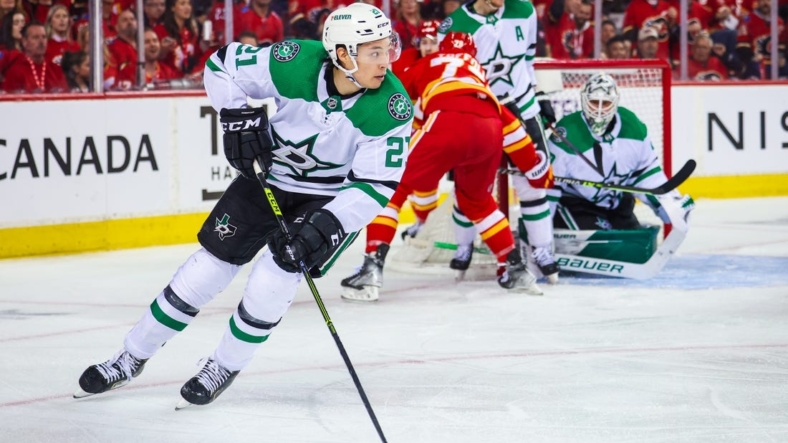 May 11, 2022; Calgary, Alberta, CAN; Dallas Stars left wing Jason Robertson (21) controls the puck against the Calgary Flames during the second period in game five of the first round of the 2022 Stanley Cup Playoffs at Scotiabank Saddledome. Mandatory Credit: Sergei Belski-USA TODAY Sports