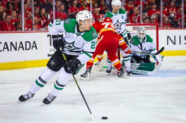 May 11, 2022; Calgary, Alberta, CAN; Dallas Stars left wing Jason Robertson (21) controls the puck against the Calgary Flames during the second period in game five of the first round of the 2022 Stanley Cup Playoffs at Scotiabank Saddledome. Mandatory Credit: Sergei Belski-USA TODAY Sports